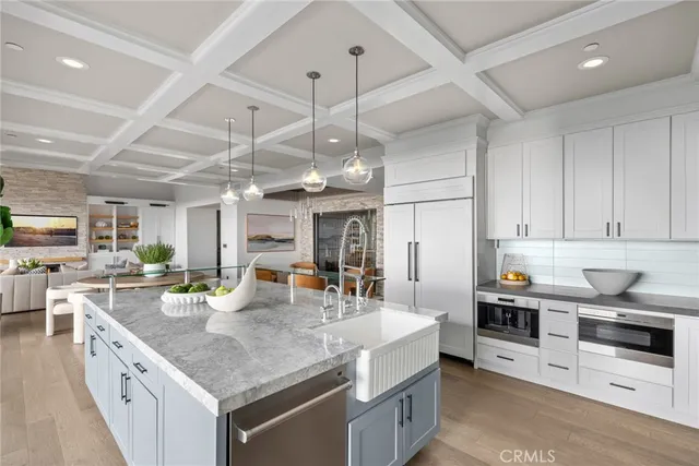 a kitchen with a sink a counter space appliances and cabinets