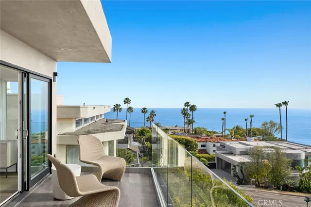 a living room with furniture a fireplace and potted plants