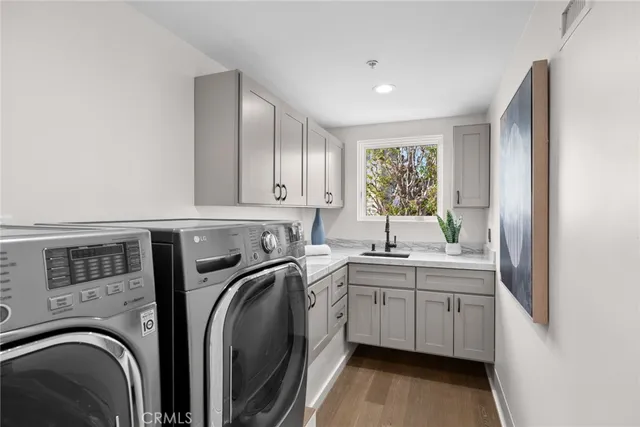 a utility room with sink dryer and washer