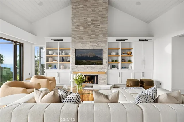 a living room with furniture a flat screen tv and a fireplace