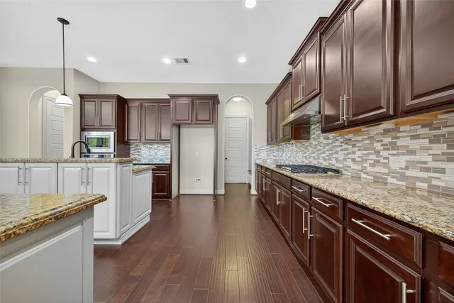 a view of a livingroom with wooden floor staircase and a large window