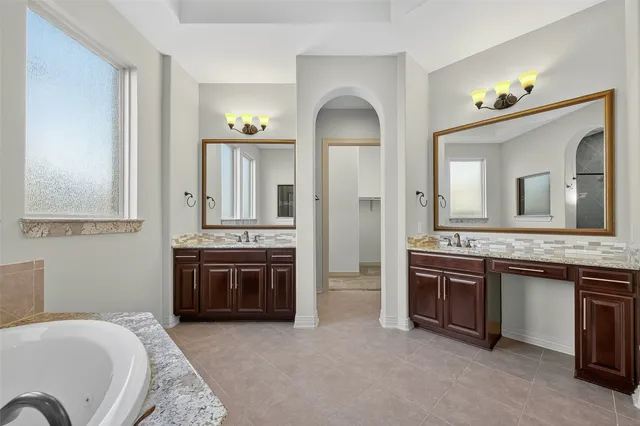an empty room with closet and a chandelier fan