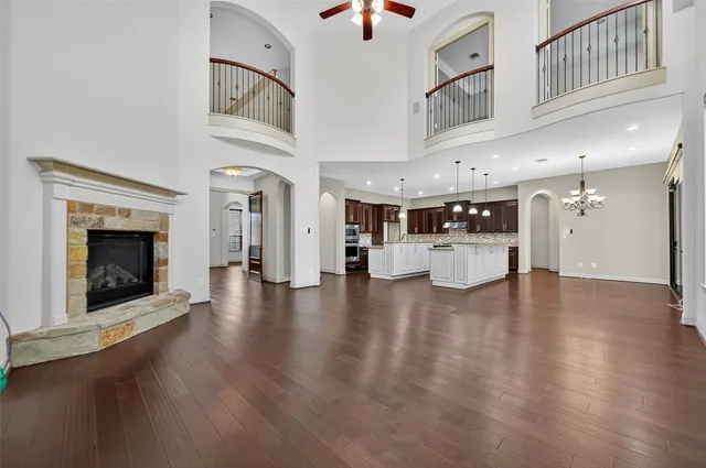 a large white kitchen with a large window a sink and stainless steel appliances