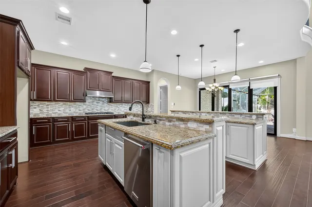 a kitchen with stainless steel appliances granite countertop a stove and a refrigerator