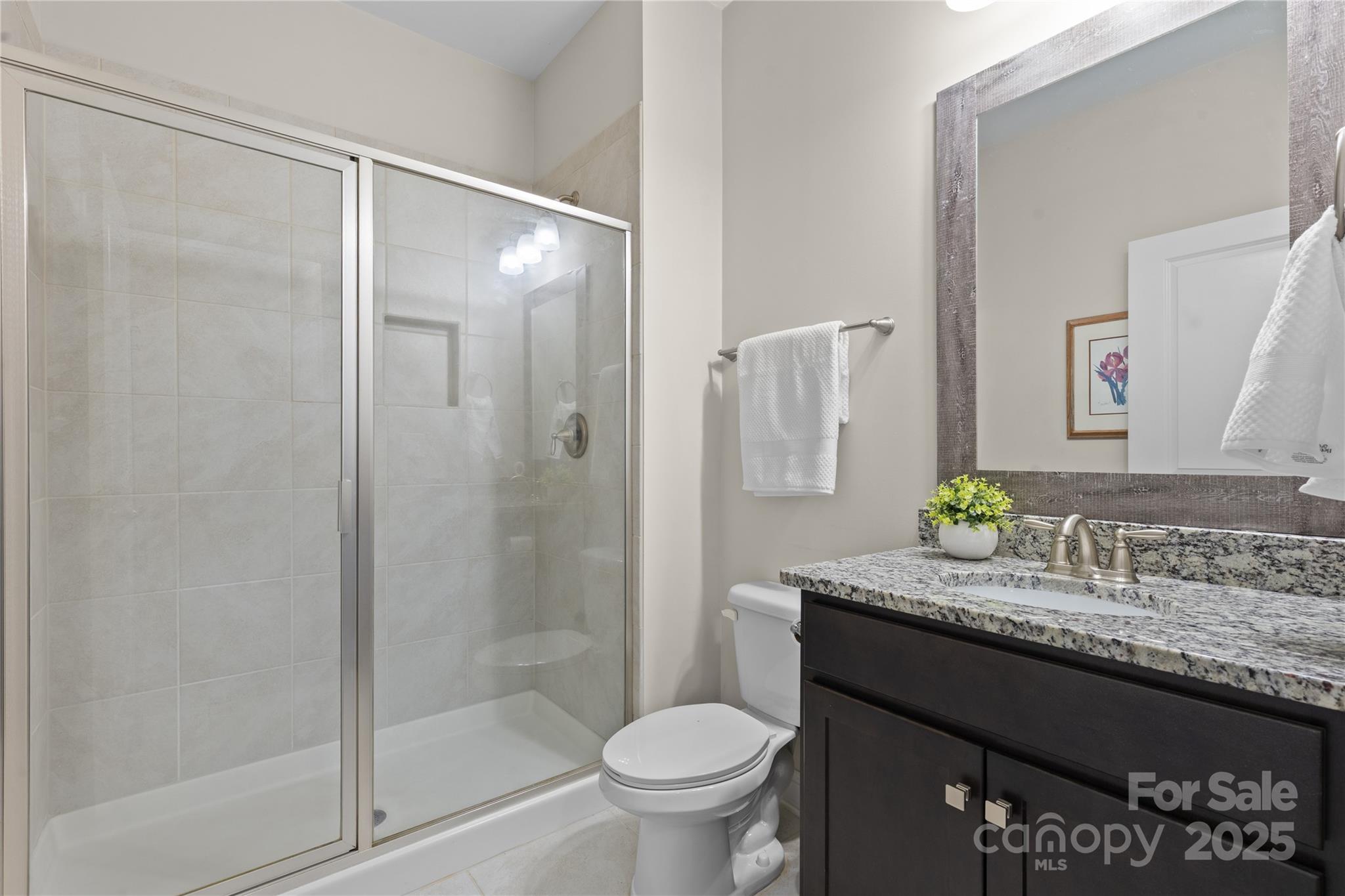 7035 Bareland Road Fort Mill, SC 29707 - Photo 21 of 47 a bathroom with a granite countertop sink toilet and shower