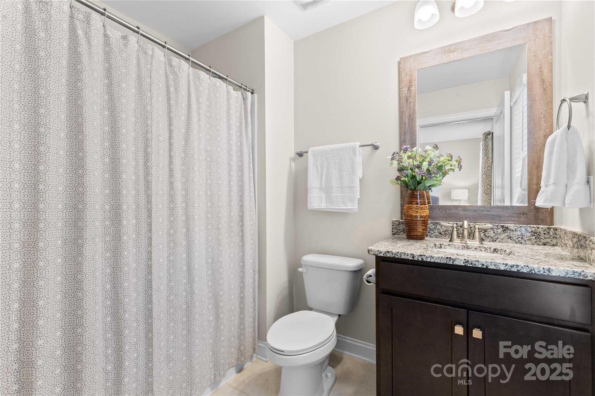 7035 Bareland Road Fort Mill, SC 29707 - Photo 35 of 47 a bathroom with a granite countertop sink and a toilet