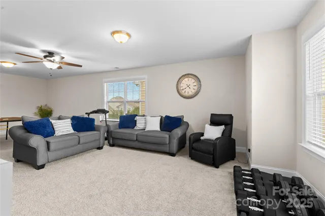 a living room with furniture a couch and a window