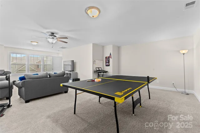 a living room with furniture pool table and a window