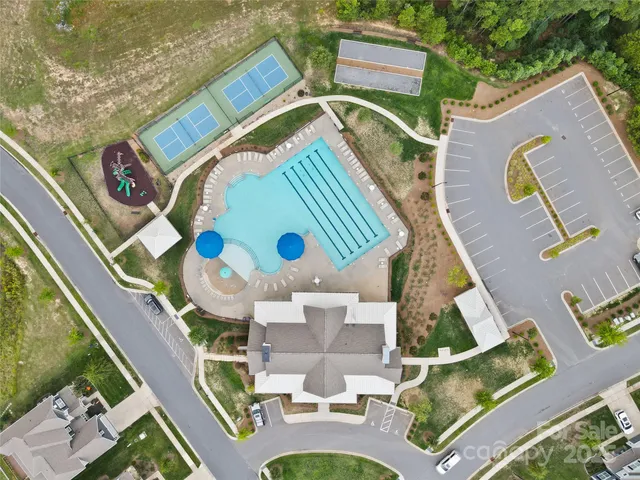 an aerial view of a house swimming pool and outdoor seating