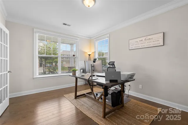 a view of a workspace with furniture and a window