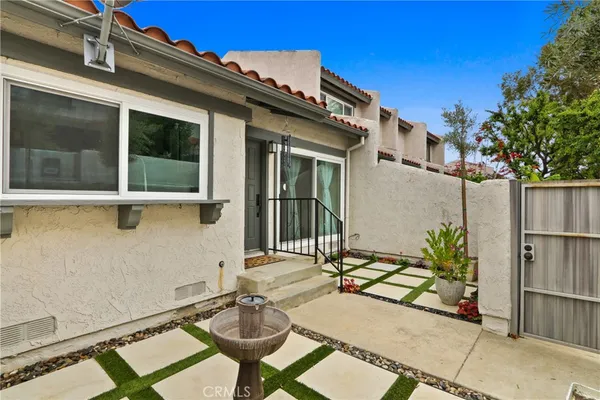 a backyard of a house with table and chairs