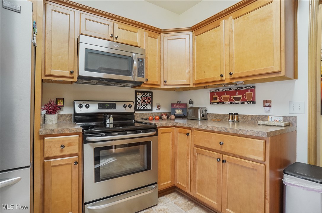 861 Susan Road Ravenna, OH 44266 - Photo 14 of 45 Kitchen with appliances with stainless steel finishes and light brown cabinetry