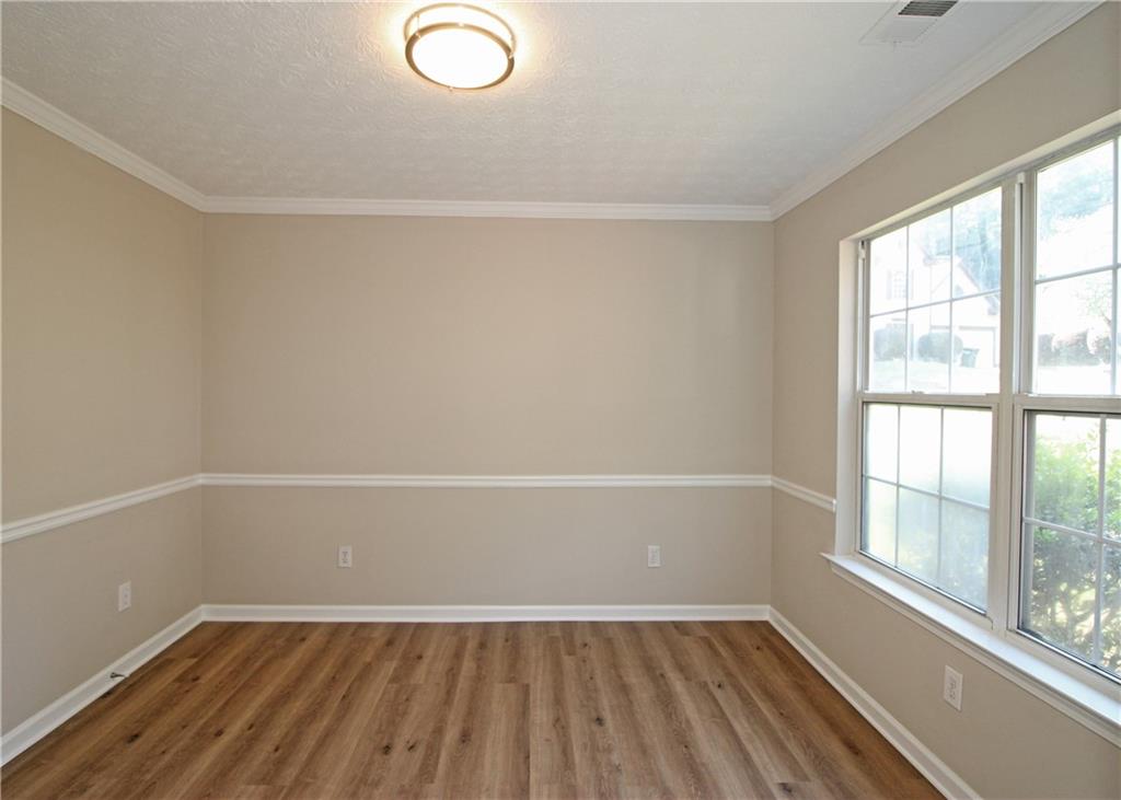 1334 Ambercrest Way Austell, GA 30168 - Photo 7 of 20 wooden floor in an empty room with a window