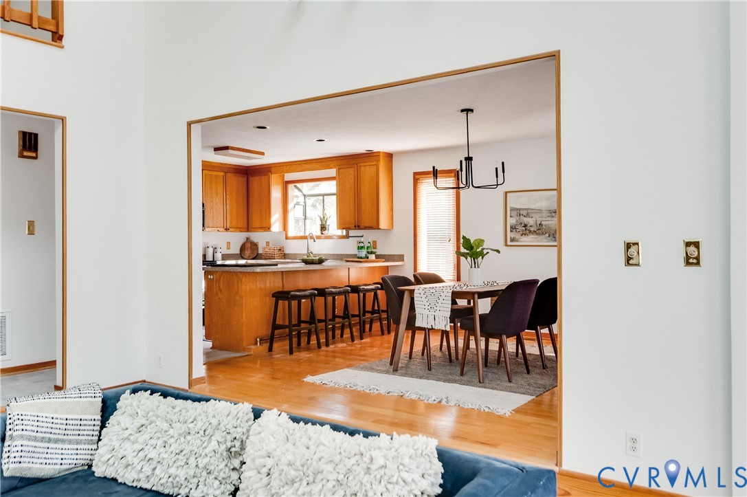 14722 Swift Water Road Chesterfield, VA 23838 - Photo 18 of 50 a living room with furniture a rug and a dining table