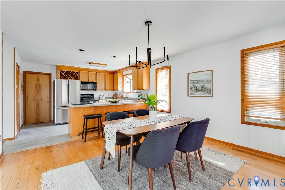 14722 Swift Water Road Chesterfield, VA 23838 - Photo 21 of 50 a view of a dining room with furniture and wooden floor