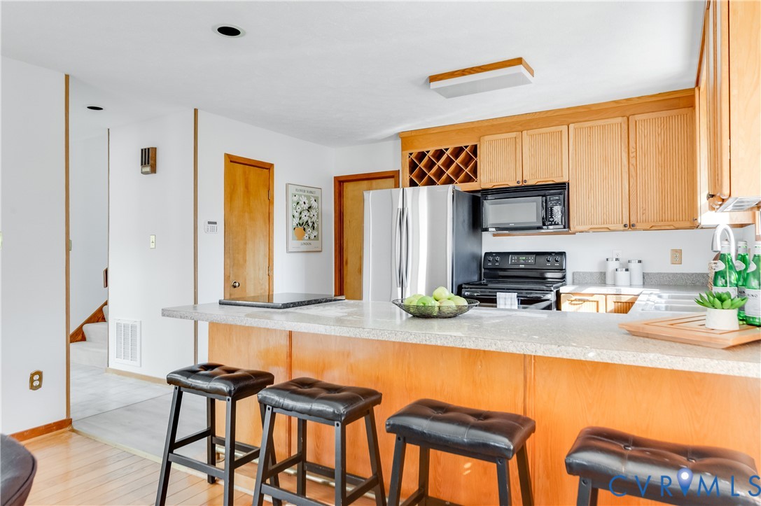 14722 Swift Water Road Chesterfield, VA 23838 - Photo 23 of 50 a kitchen with stainless steel appliances granite countertop a stove a sink and a microwave