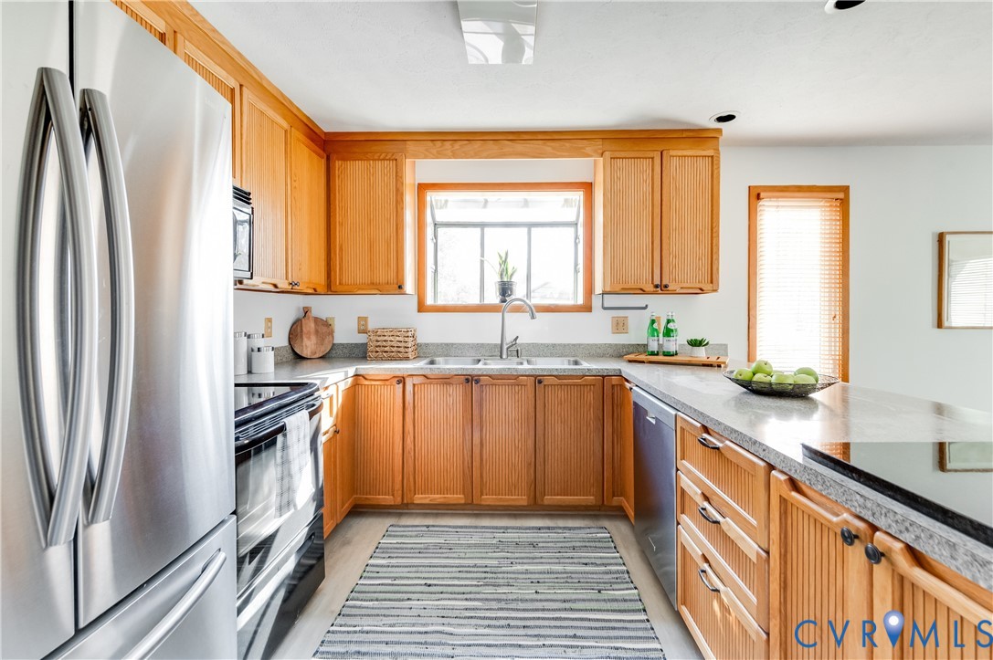 14722 Swift Water Road Chesterfield, VA 23838 - Photo 25 of 50 a kitchen with stainless steel appliances granite countertop a refrigerator a sink and white cabinets