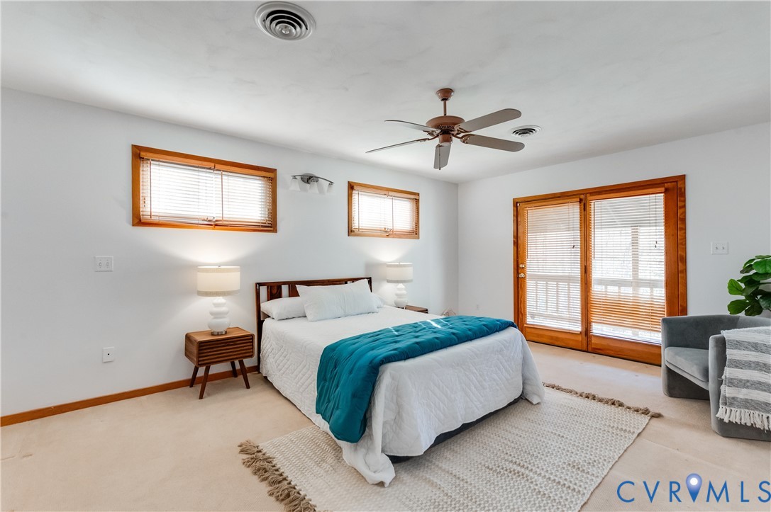 14722 Swift Water Road Chesterfield, VA 23838 - Photo 30 of 50 a bedroom with a large bed and a chandelier