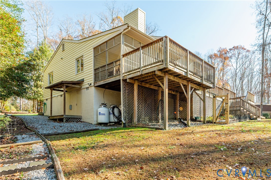 14722 Swift Water Road Chesterfield, VA 23838 - Photo 40 of 50 a view of a white house with large windows and a small yard