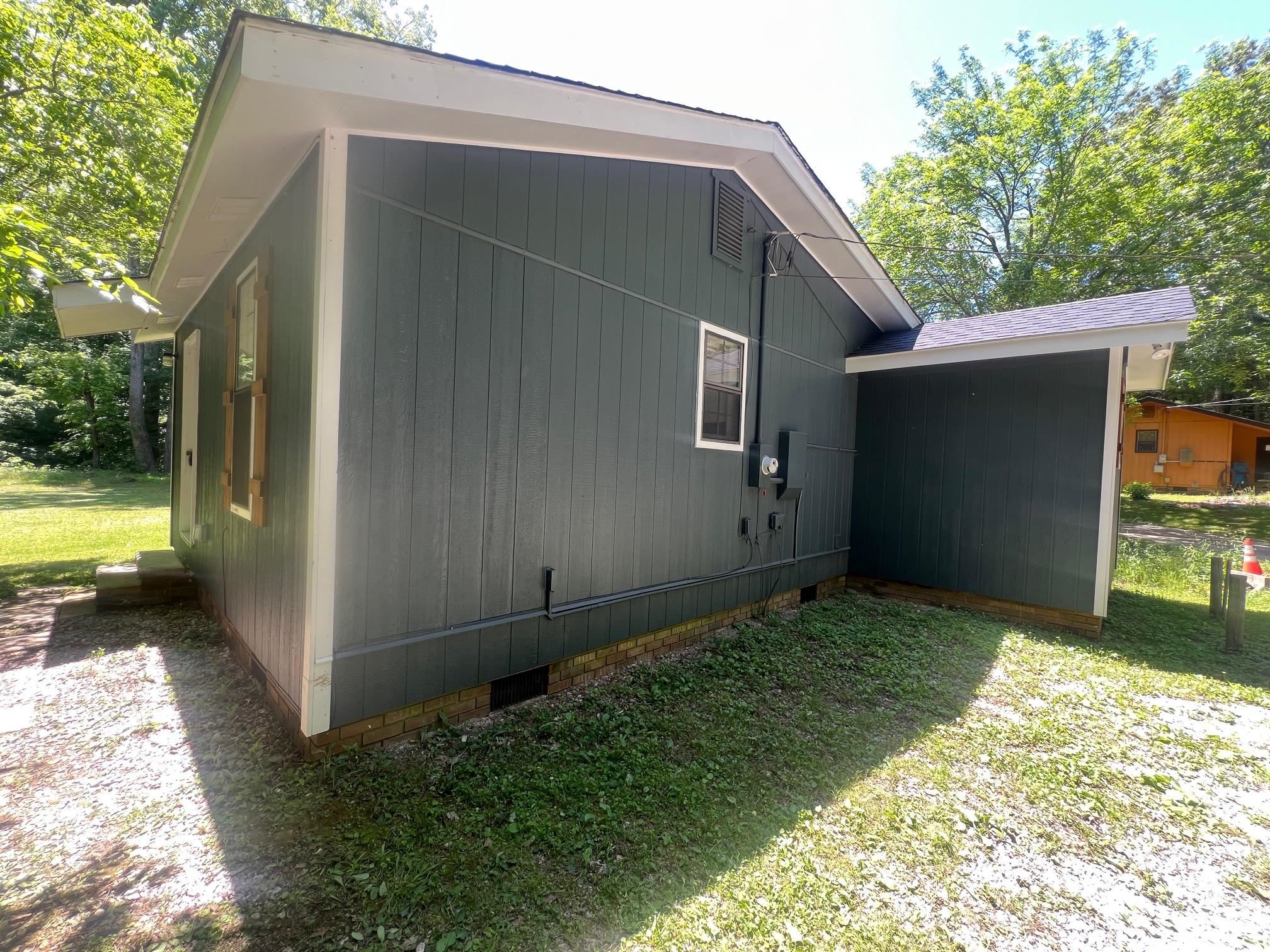 90 Double Springs Loop Savannah, TN 38372 - Photo 19 of 31 a backyard of a house with a yard and garage