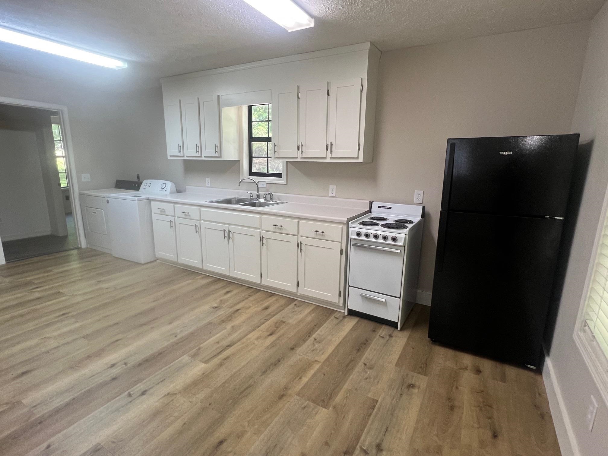 90 Double Springs Loop Savannah, TN 38372 - Photo 4 of 31 a kitchen with granite countertop a refrigerator a sink and dishwasher