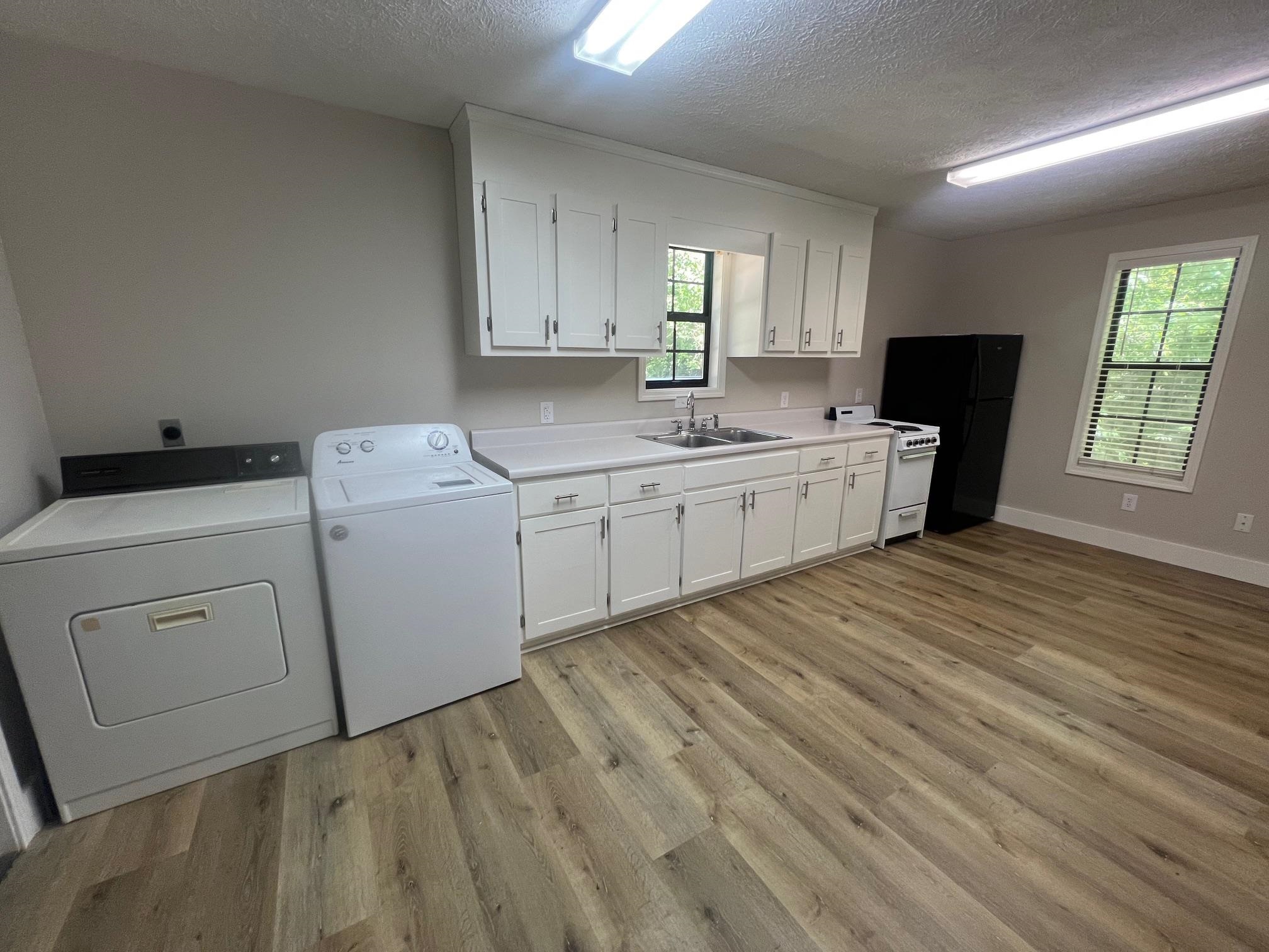 90 Double Springs Loop Savannah, TN 38372 - Photo 5 of 31 a room with a washer dryer and cabinets