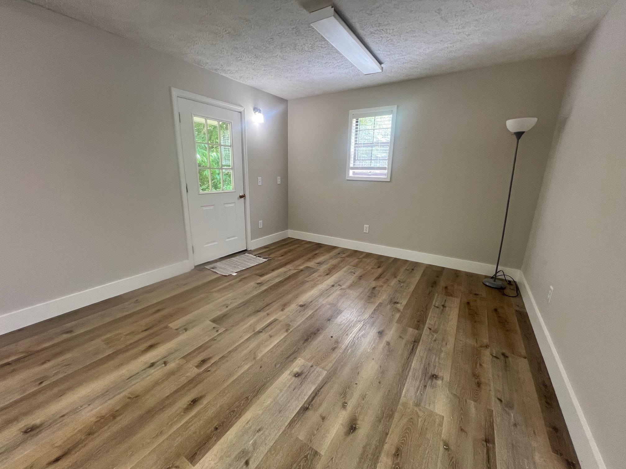 90 Double Springs Loop Savannah, TN 38372 - Photo 8 of 31 wooden floor in an empty room with a window