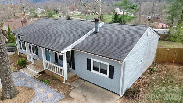 a aerial view of a house with backyard and deck