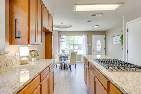 a kitchen with sink stove and cabinets