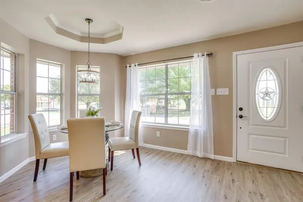 a view of a dining room with furniture window and wooden floor
