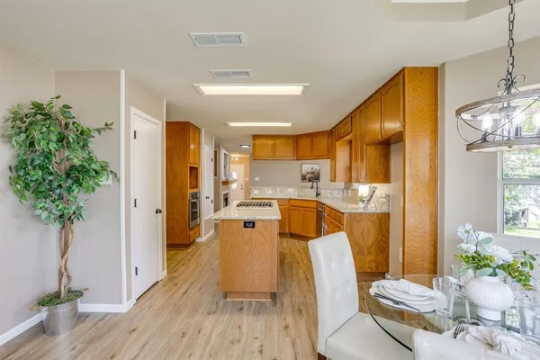 a living room with dining room and wooden floor