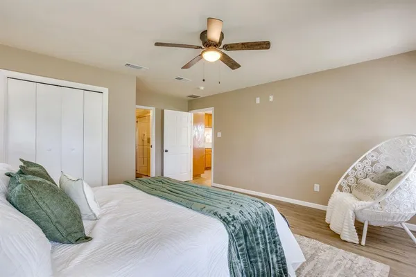 a bedroom with a bed and a chair