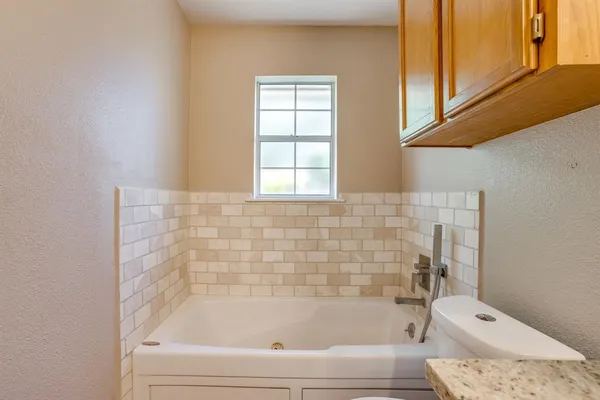 a bathroom with a bathtub and shower