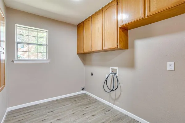 a bathroom with a granite countertop sink and cabinets