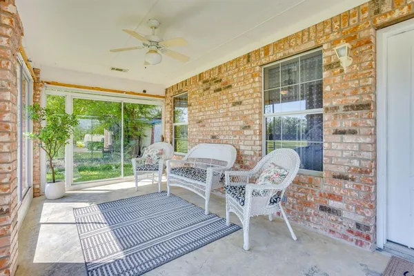 a view of a patio with a table and chairs