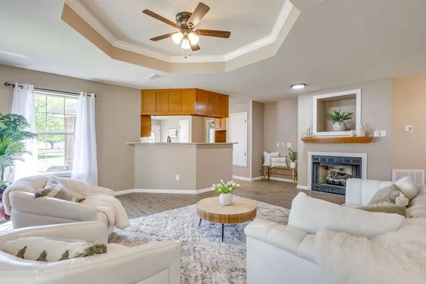 a living room with furniture fireplace and a large window