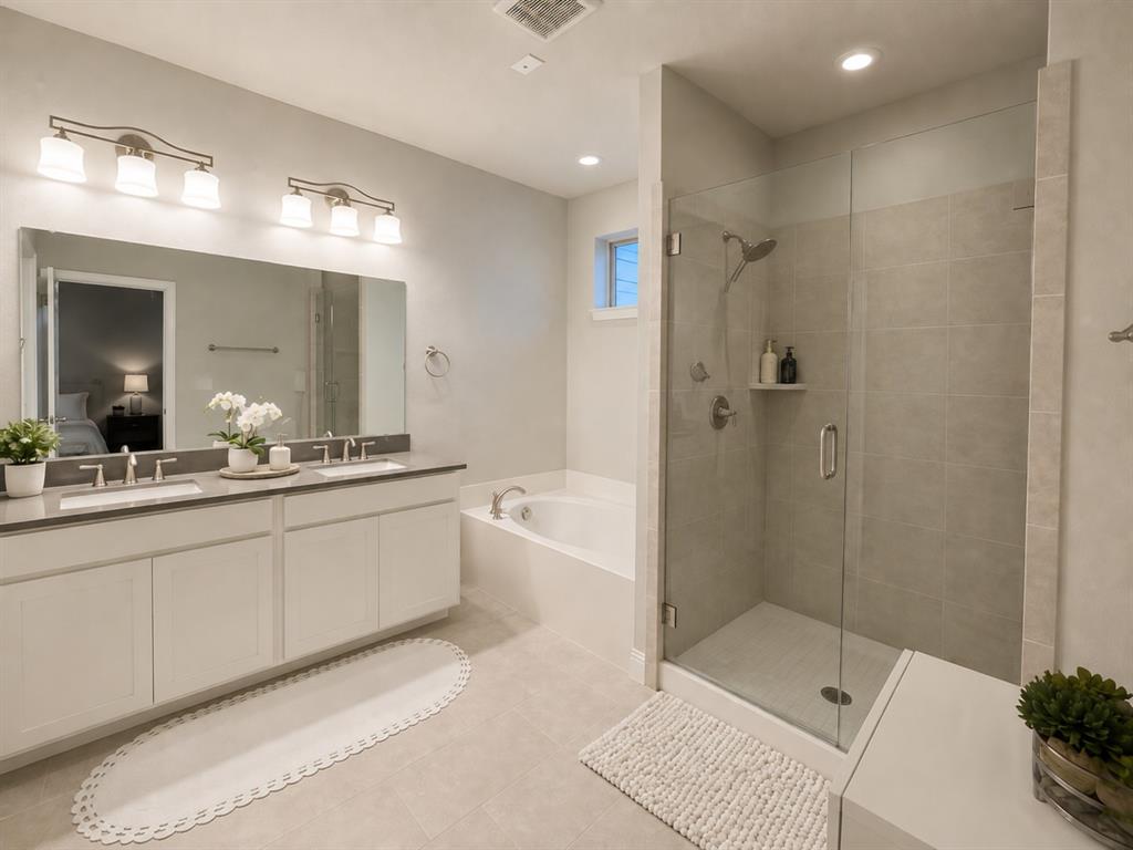 8235 Snapdragon Way Dallas, TX 75252 - Photo 16 of 29 Spacious bathroom featuring a dual vanity with undermount sinks, a large mirror, and two three-light vanity fixtures