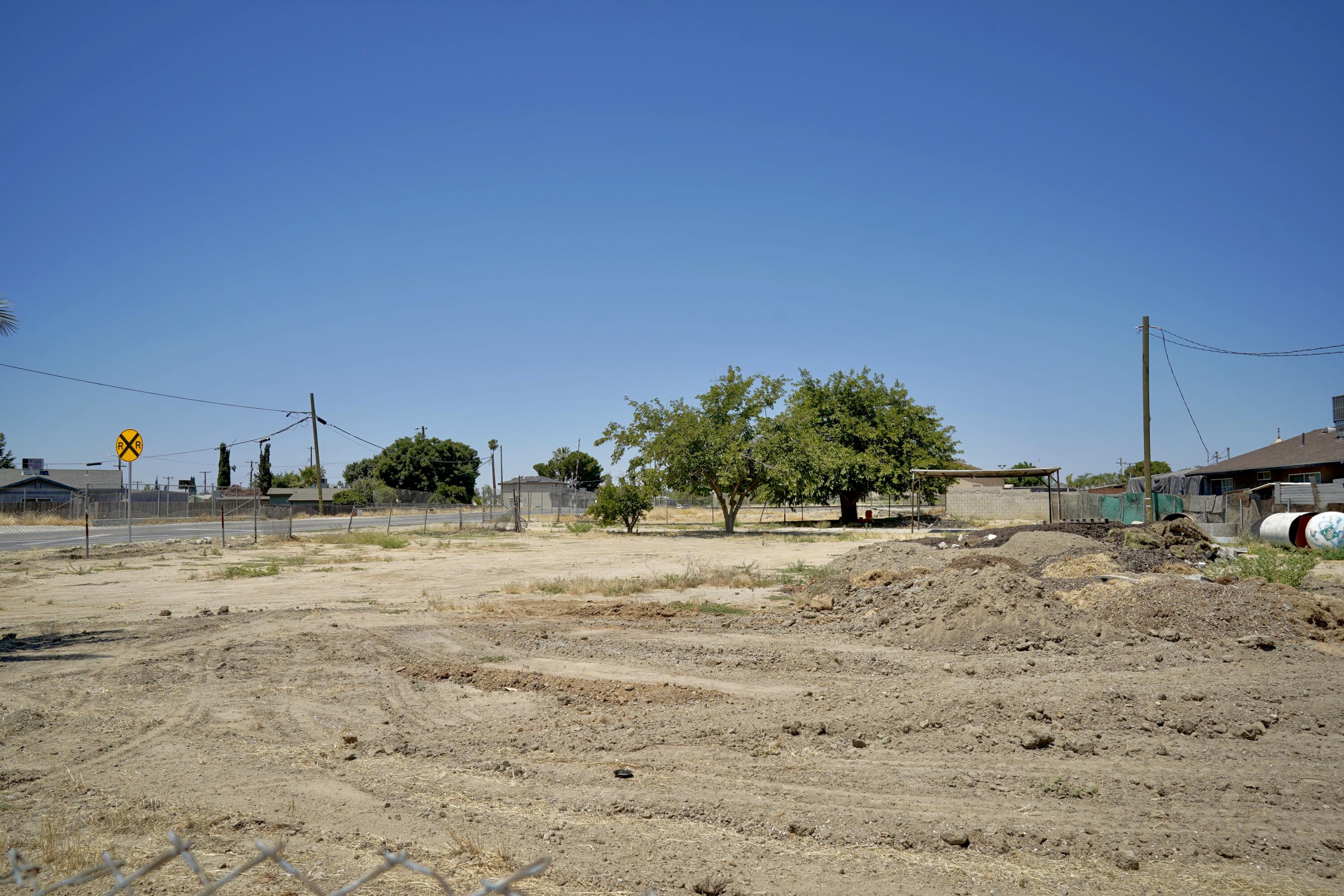 326 Wilson Road Bakersfield, CA 93307 - Photo 5 of 26 a view of a dry yard with wooden fence