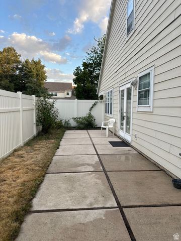 254 Meadow Lane Centerville, UT 84014 - Photo 32 of 34 Expansive concrete patio offering direct outdoor access through double French doors