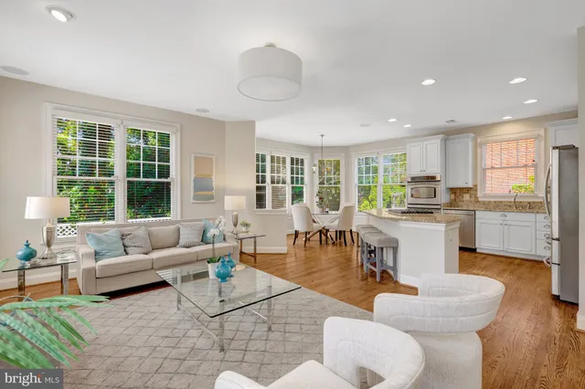 a living room with fireplace furniture and a large window