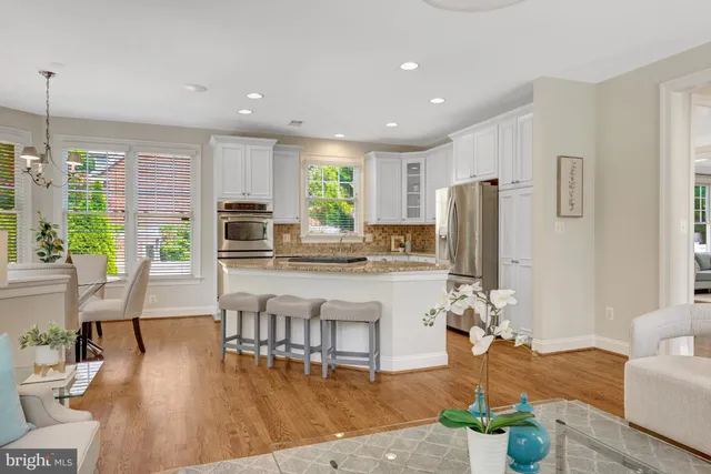 a living room with fireplace furniture and a large window