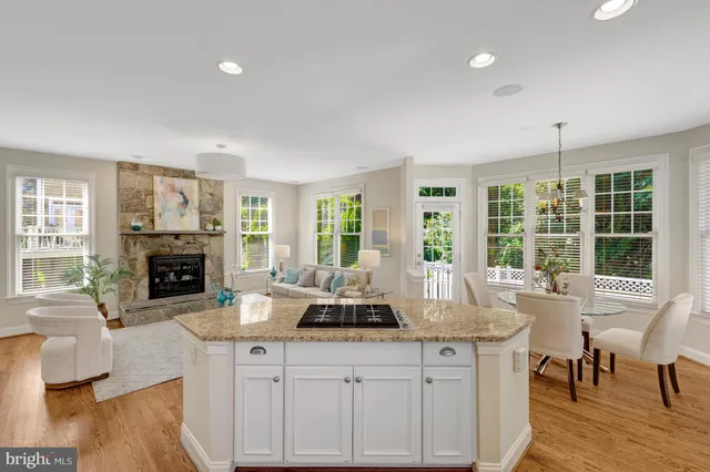 a kitchen with kitchen island granite countertop a refrigerator stove and sink