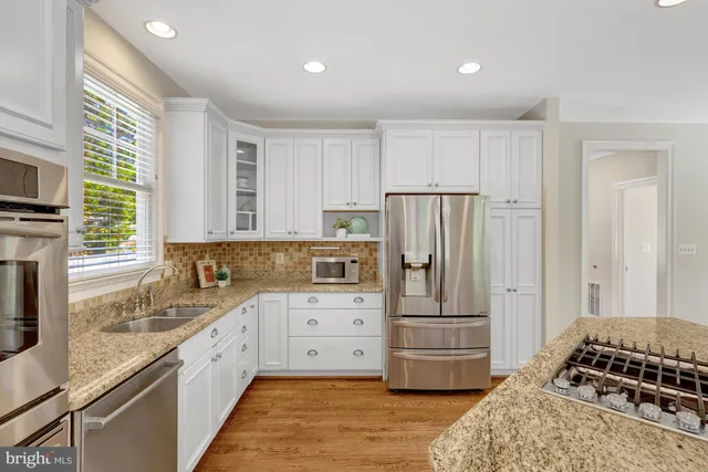 a living room with fireplace furniture and a chandelier