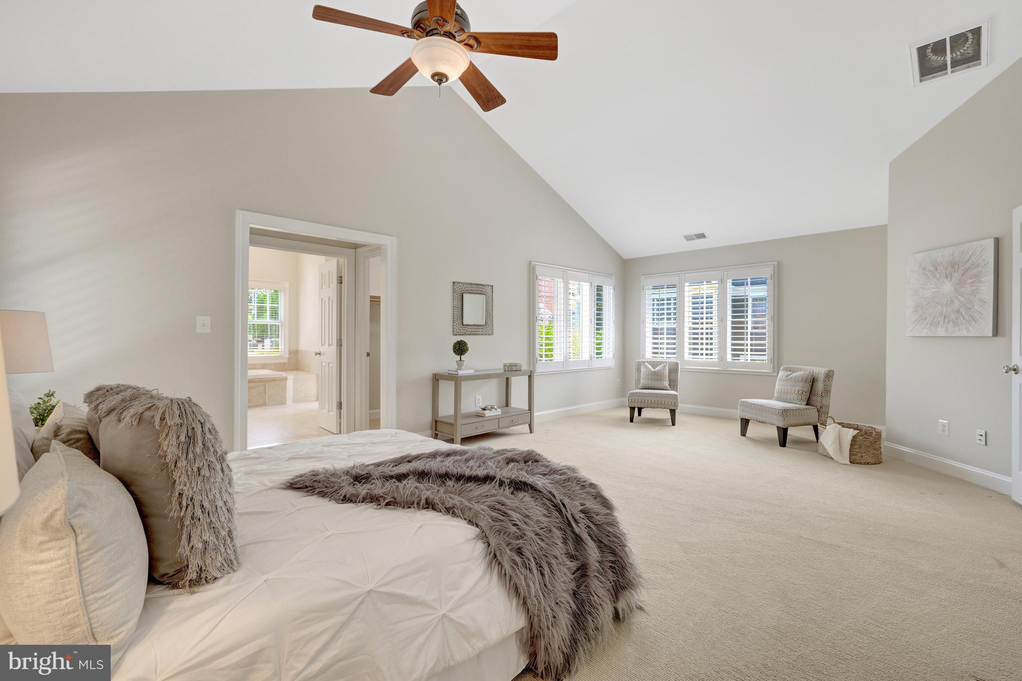 1519 Pathfinder Lane McLean, VA 22101 - Photo 28 of 54 a spacious bedroom with a bed a couch and windows