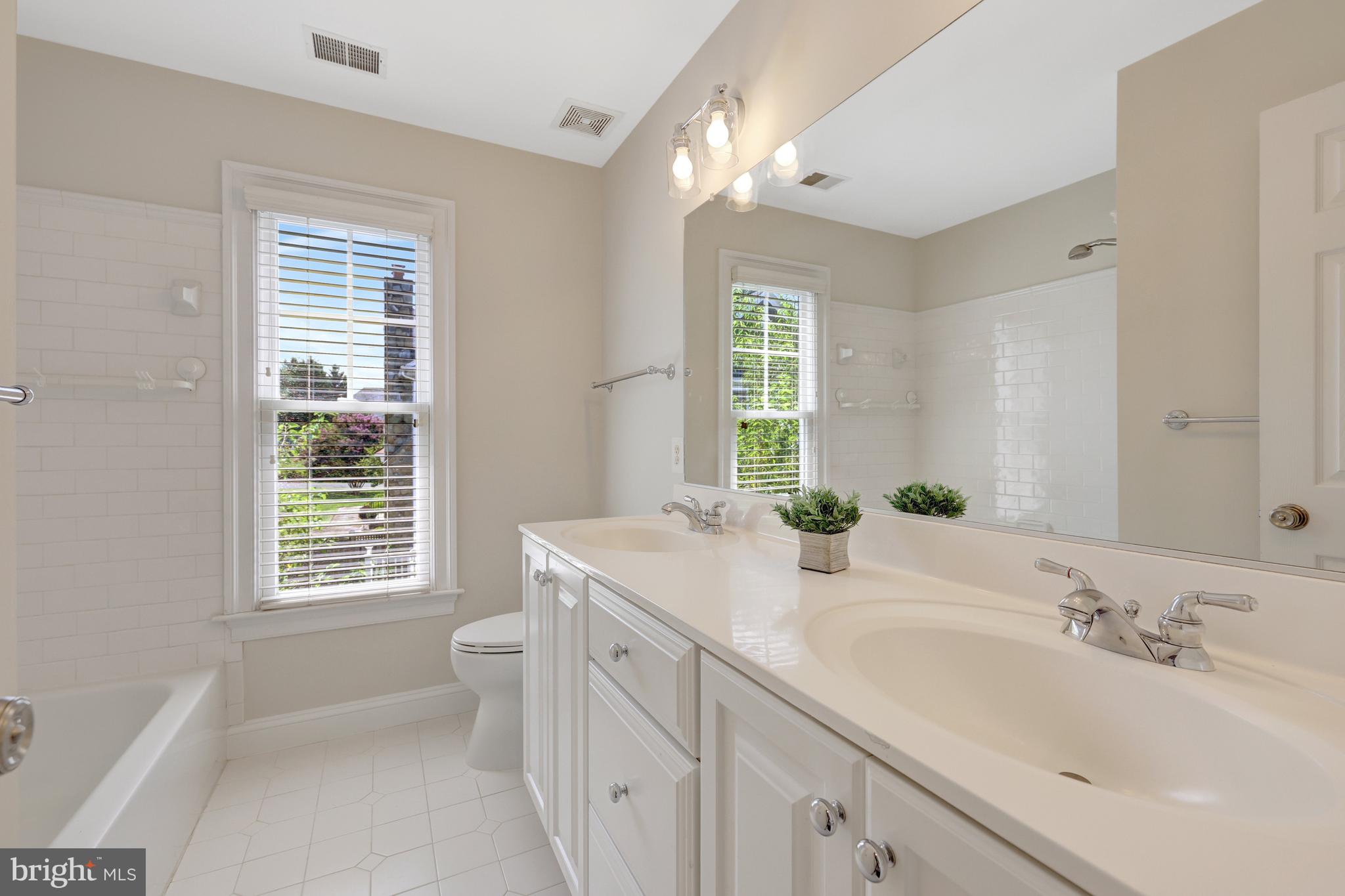 1519 Pathfinder Lane McLean, VA 22101 - Photo 36 of 54 a bathroom with double vanity sink a mirror and a bathtub