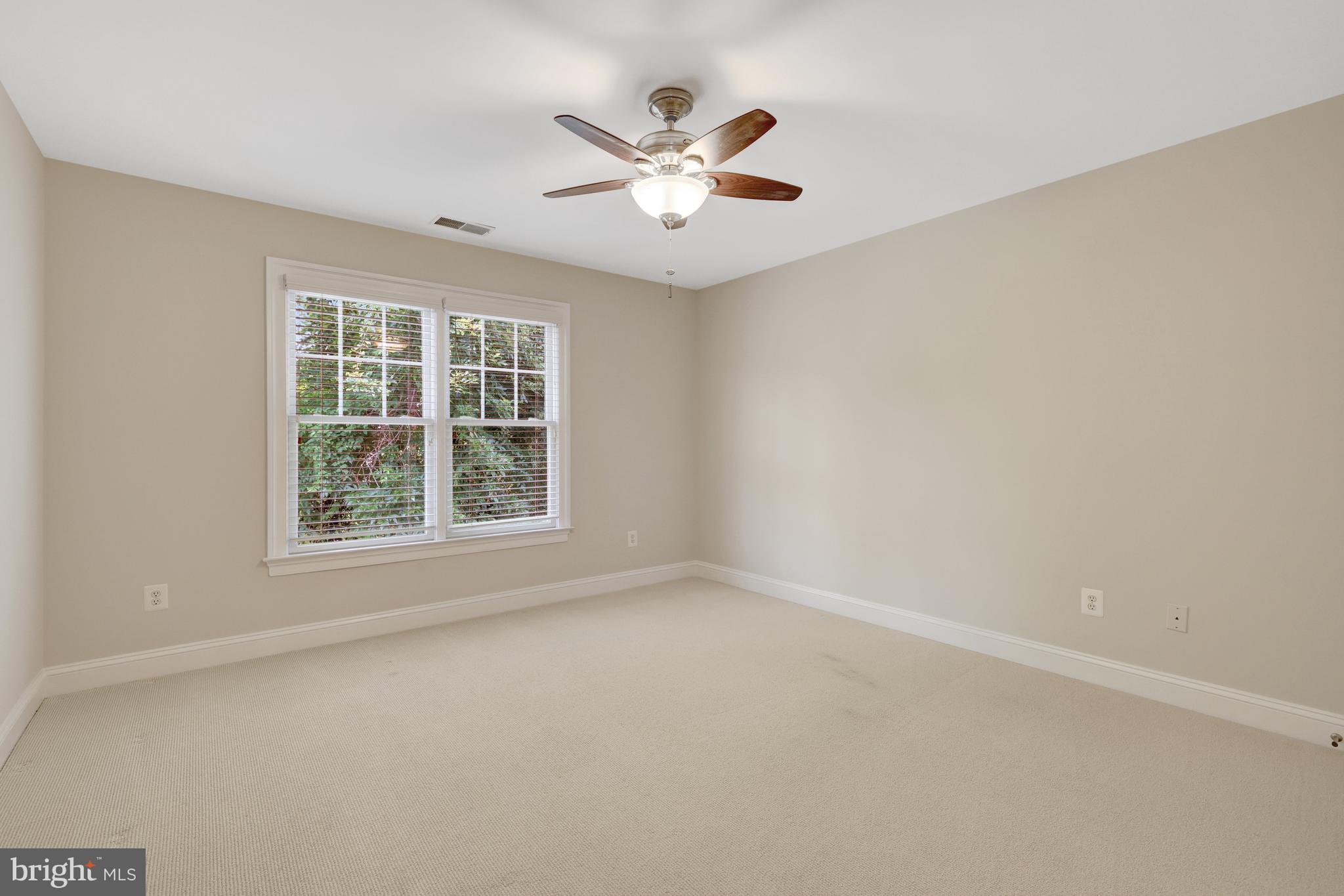 1519 Pathfinder Lane McLean, VA 22101 - Photo 40 of 54 an empty room with window and ceiling fan