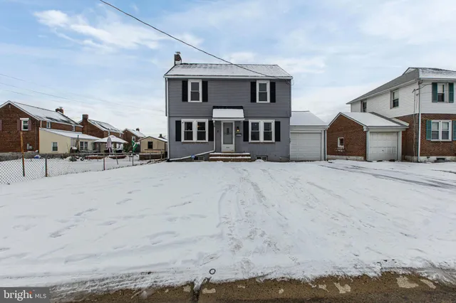 a view of a house with a snow in the background