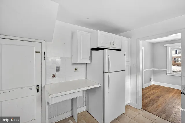 a white refrigerator freezer sitting inside of a kitchen