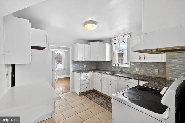 a kitchen with stainless steel appliances granite countertop a sink and a stove