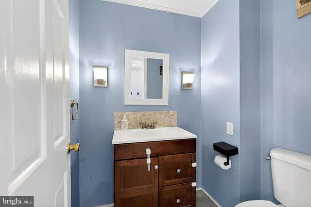 a bathroom with a sink a toilet and mirror
